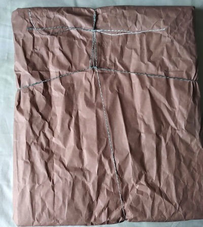 Brown wrapping paper for the framed picture with string tied up in knots